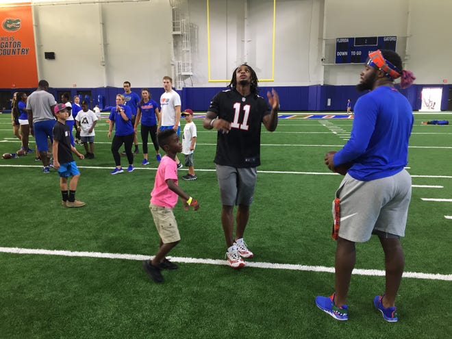 UF football players hang out with children Saturday at the Brandon Ling Memorial Sports Camp in Gainesville. The event allows children diagnosed with cancer to have fun with athletes for a day. [Darlena Cunha/Correspondent]