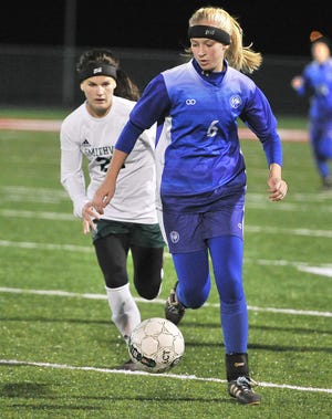 Chippewa's Bailey Clark (6) dribbles the ball away from Smithville's Jenna Jundzilo (back) during their Div. III district semifinal match Monday at Norwayne Community Stadium. Clark scored all three of the Chipps' goals in their 3-0 victory over the Smithies to help her team advance to a district final against Northwestern.