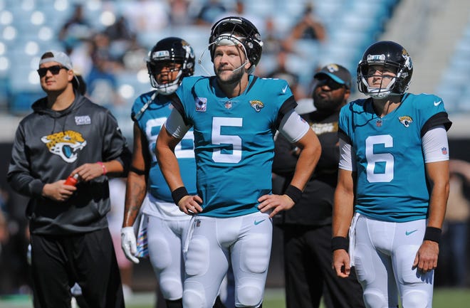 Jaguars quarterback Blake Bortles (5) and Cody Kessler (6) watch the Chargers vs Titans game during warmups before Sunday's 20-7 loss to the Texans. [Bob Self/Florida Times-Union]