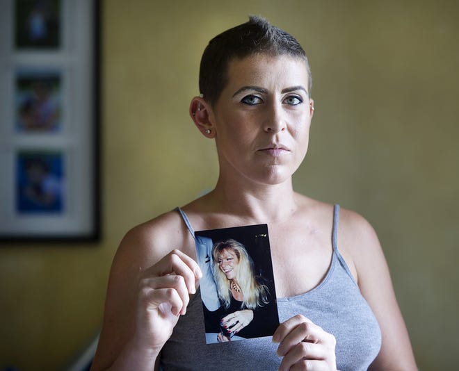 Jessica Connell, 29, who is being treated for breast cancer, holds a photograph of her mother Linda, in her Greenacres home Friday October 12, 2018. Connell lost her mother to breast cancer. [Meghan McCarthy/palmbeachdailynews.com]