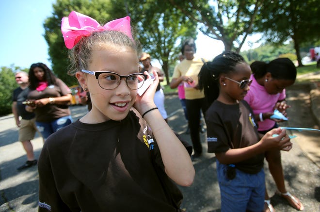 Katelynne Hopper, 11, listens as her butterfly prepares to take flight at Cancer Survivors Day held at Carolinas HealthCare System Cleveland on Saturday, Sept. 22, 2018. [Brittany Randolph/The Star]