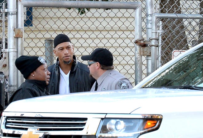 Former Carolina Panthers NFL football player Rae Carruth, center, exits the Sampson Correctional Institution in Clinton, N.C., Monday, Oct. 22, 2018. Former NFL wide receiver Rae Carruth has been released from prison after serving 18 years for conspiring to murder the mother of his unborn child. The Carolina Panthers’ 1997 first-round draft pick was released Monday from Sampson Correctional Institution in Clinton, North Carolina after completing his sentence. (Jeff Siner/The Charlotte Observer via AP)