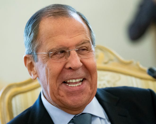 Russian Foreign Minister Sergey Lavrov smiles as he speaks to Madagascar's Foreign Minister Eloi Maxime Alphonse Dovo during their meeting in Moscow, Russia, Monday, Oct. 22, 2018. Lavrov will meet with U.S. National Security Adviser John Bolton for high-tension talks in Moscow, after President Donald Trump announced his intention to withdraw from a landmark nuclear weapons treaty. (AP Photo/Alexander Zemlianichenko)
