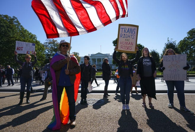 The National Center for Transgender Equality, NCTE, and the Human Rights Campaign gather on Pennsylvania Avenue in front of the White House in Washington on Monday, Oct. 22, 2018, for a #WontBeErased rally. (AP Photo/Carolyn Kaster)