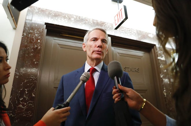 Sen. Rob Portman, R-Ohio, stops to answer questions for members of the media as he returns to a hearing on Capitol Hill in Washington, Tuesday, Sept. 18, 2018. (AP Photo/Pablo Martinez Monsivais)