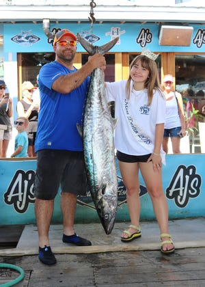 Paul Profitt Jr. landed this 52.6-pound king mackerel while fishing with Capt. John Tenore on the Dawn Patrol. His catch is leading in the 25-foot-and-under Charter Boat Division of the Destin Fishing Rodeo. Also pictured is Miss Destin Ellen Brown. [FOR REEL PHOTOS/CONTRIBUTED PHOTO]