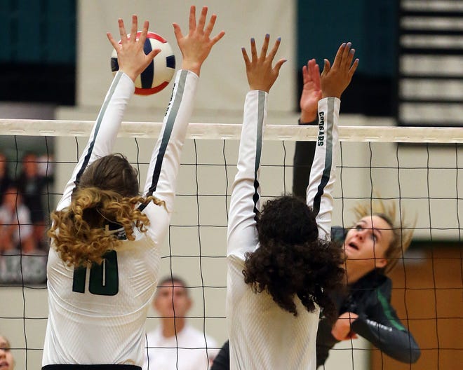 Connally Cougar Alyssa McClure (10) blocks the volleyball at the net against the Cedar Park Timberwolves in the Cougars' gym on Oct. 23. [Jamie Harms for AMERICAN-STATESMAN]