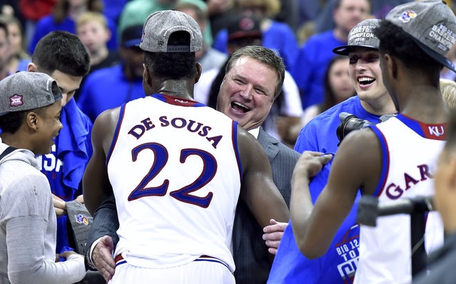 Silvio De Sousa (22) receives a big hug from Kansas head coach Bill Self after an 81-70 win over West Virginia in the Big 12 championship game. The sophomore forward will be held out of competition while an eligibility review is conducted, Jayhawks coach Bill Self announced Wednesday. [RICH SUGG/KANSAS CITY STAR]