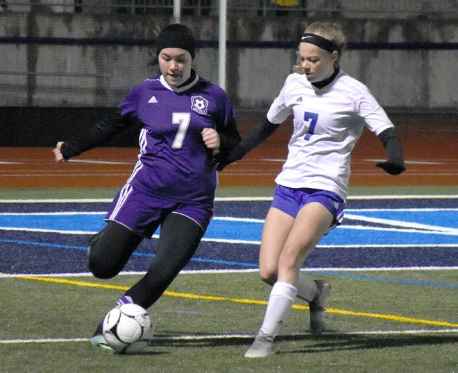 Little Falls Mountie Emma Rasch, left, prepares to clear the ball from the defensive end of the field at Central Valley Academy with Dolgeville Blue Devil Gabby Kenyon pressuring her during the second half of Tuesday's game. [JON RATHBUN/TIMES TELEGRAM]