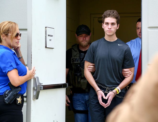 Austin Harrouff is transported by detectives to the Martin County Jail from St. Mary's Hospital on Monday, October 3, 2016. Harrouff, who allegedly fatally stabbed a Martin County couple in their home on August 15, has officially been charged with two counts of first-degree murder. [Richard Graulich/pbpost.com]