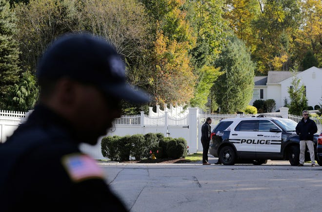 Police officers stand in front of property owned by former Secretary of State Hillary Clinton and former President Bill Clinton in Chappaqua, N.Y., on Wednesday. [AP Photo/Seth Wenig]