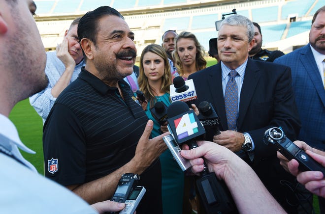 Jacksonville Jaguars owner Shad Khan, left, fields questions from the media on April 26 on his interest in buying Wembley Stadium in London. Khan withdrew his offer earlier this month. [Bob Self/GateHouse Florida]