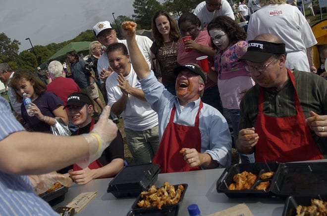 Did you know Hope Mills Commissioner Jessie Bellflowers was a wing-eating champ? Here's a photo from Ole Mill Days in 2007, when the VFW 10630 Post Commander ate 29 wings in 10 minutes. [FILE PHOTO/THE SANDSPUR]