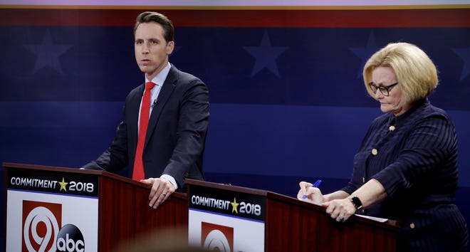 Missouri U.S. Senate candidates incumbent Democratic Sen. Claire McCaskill, right, and Republican challenger Josh Hawley wait for the start of a debate Thursday in Kansas City. [Charlie Riedel/The Associated Press]