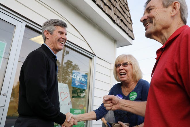 Fred Hubbell, Democratic nominee for governor, greets Nancy and Tom Courtney during a stop Wednesday at the Des Moines County Democratic Party Headquarters in Burlington. [John Lovretta/thehawkeye.com]
