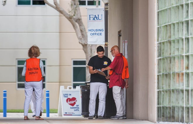 A poll worker greets a voter at a early voting location at Florida Atlantic University in Boca Raton, Florida, October 19, 2018. [GREG LOVETT/pbpost.com]