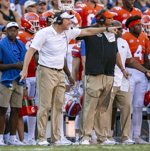 Florida head coach Dan Mullen, left, and defensive coordinator Todd Grantham (to Mullen's left) have helped turn the Gators around in their first season together in Gainesville. [Alan Youngblood/Staff photographer]