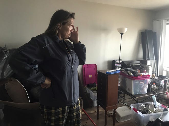 This Oct. 23, 2018 photo shows Regina Ferrell, a fourth grade teacher in Panama City, inside her damaged condo in Panama City, Fla. Since Hurricane Michael swept through the area, many teachers like Ferrell are sleeping in half-destroyed homes, living in cars or staying in their classrooms. (AP Photo/Tamara Lush)