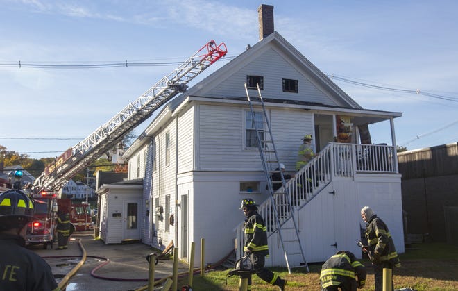 Firefighters survey the damage of a two-alarm fire in Scituate on Friday, Oct. 26 (Joe Difazio/Patriot Ledger)
