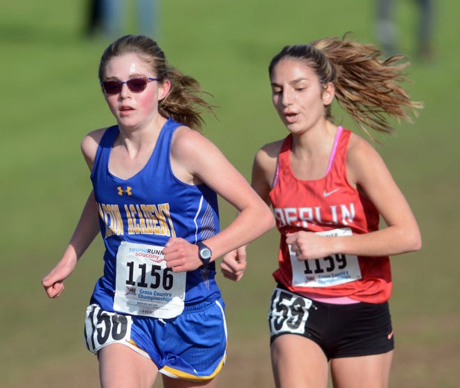 Bacon Academy’s Jordan Malloy and Berlin’s Juliana Cancellieri sprint to the finish during the Class M girls cross country championship meet at Wickham Park. Malloy placed sixth to earn All-State honors. [Aaron Flaum/NorwichBulletin.com]