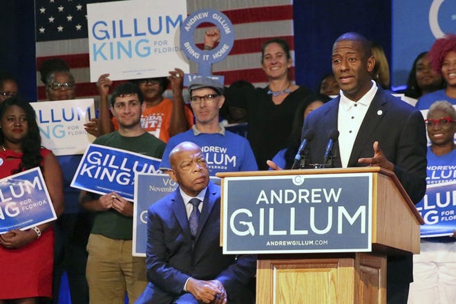Tallahassee Mayor Andrew Gillum, the Democratic nominee for the Governor of Florida, accompanied by U.S. Rep. John Lewis, left,, speaks to students at a Vote Early, Vote Loud Rally at Florida Memorial University on Thursday. The candidate is making an appearance at the University of Florida on Friday. [Emily Michot/Miami Herald via AP]