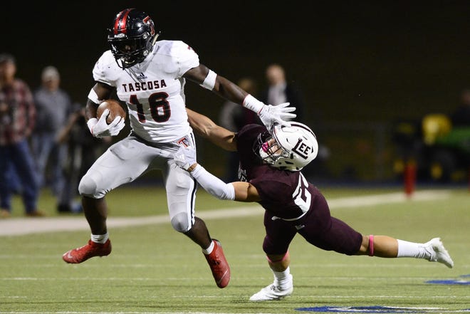 Tascosa's King Doerue (16) puts off a tackle from Lee's Damian Garcia (23) at Grande Communications Stadium on Friday night, a game Tascosa won 49-26. With that win, the Rebels just need to split their final two games to clinch a playoff spot from District 2-6A. [James Durbin/For the Globe-News]