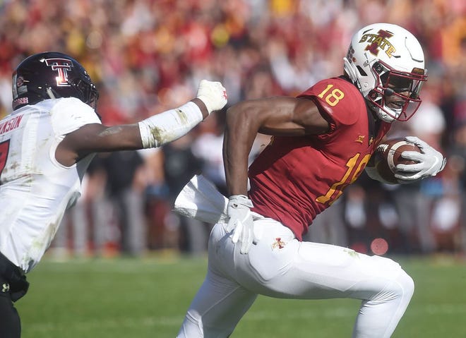 Iowa State wide receiver Hakeem Butler battles for few yards after making a catch around Texas Tech's safety Jah'Shawn Johnson during the third quarter of the Cyclones' 40-31 win.
