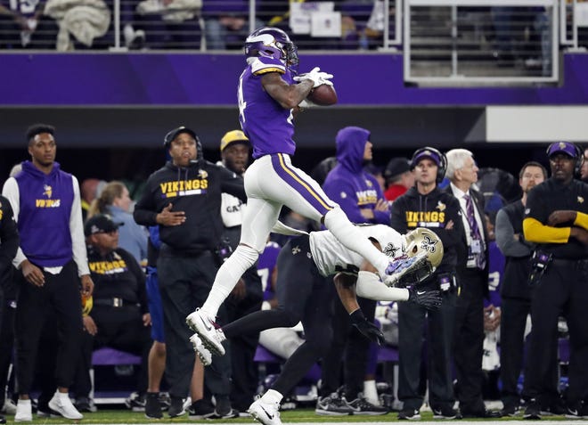 Minnesota Vikings wide receiver Stefon Diggs (14) makes a catch over New Orleans Saints free safety Marcus Williams (43) on his way to the game-winning touchdown during a playoff game on Jan. 14 in Minneapolis. [AP Photo/Jeff Roberson, File]