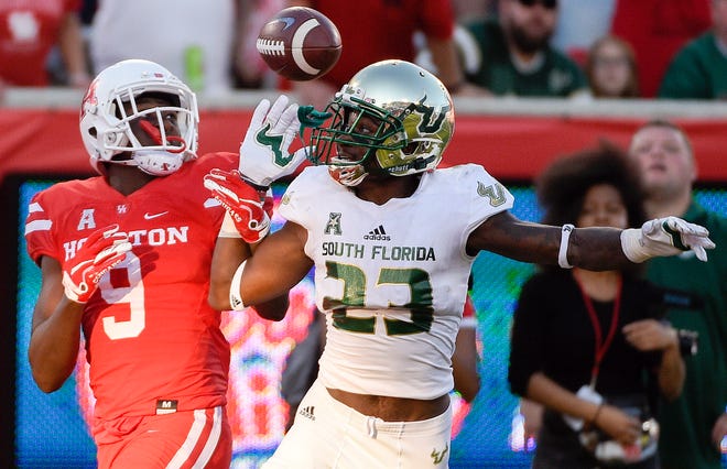 USF's Mazzi Wilkins (23) breaks up a pass intended for Houston's Courtney Lark during the second half Saturady in Houston. [Associated Press/Eric Christian Smith]