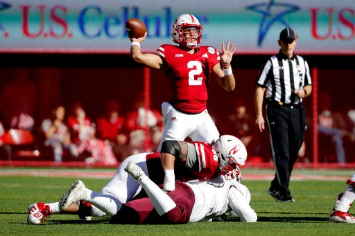 Nebraska quarterback Adrian Martinez (2) throws behind a block by offensive lineman Boe Wilson (56) during the first half of an NCAA college football game against Bethune-Cookman in Lincoln, Neb., Saturday, Oct. 27, 2018. (AP Photo/Nati Harnik)