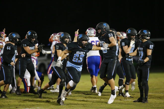 Ponte Vedra's Michael Soncrant (63) celebrates a Bolles turnover, one of four in the game, in the Sharks' 43-12 win Friday. [David Rosenblum/Contributed]