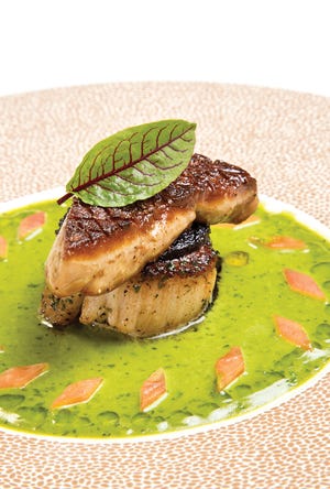Scallop Rossini with a squid ink crust, basil sauce and tomato “diamonds”