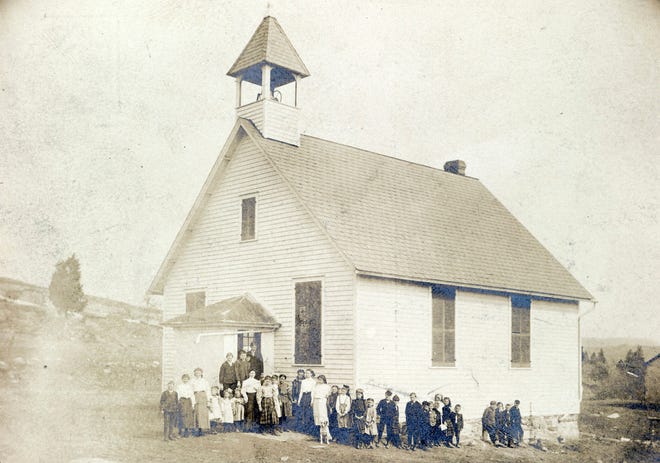 Photo submitted by Wayne T. McCabe — This picture of the Germany Flats schoolhouse was taken in the spring of 1907. There are 33 students of a wide range of ages, the teacher (in front of the door) and what is assumed to be the class or school mascot.