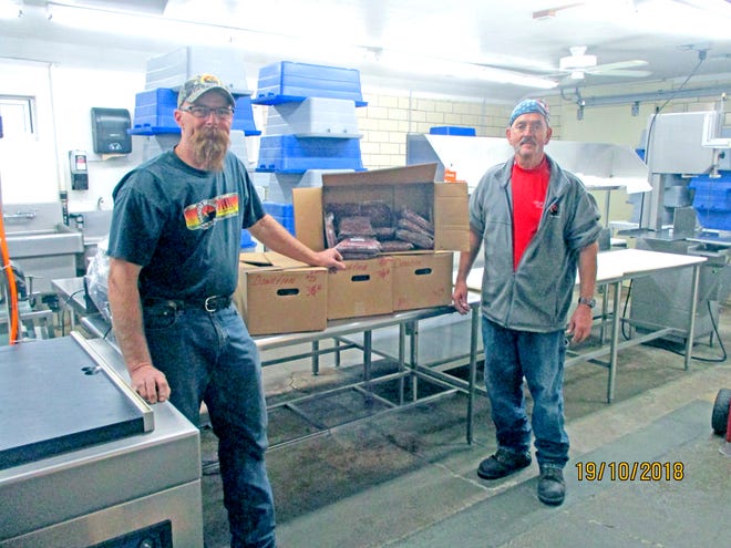 Jim Bowersock, co-coordinator of Farmers and Hunters Feeding the Hungry in Wayne County (left), and Tim Morris, co-owner of Canaan Meats in Creston, stand with boxes of processed ground venison ready to be donated. Canaan Meats also collected over $500 in FHFH donations during this year’s Wayne County Farm Tour.