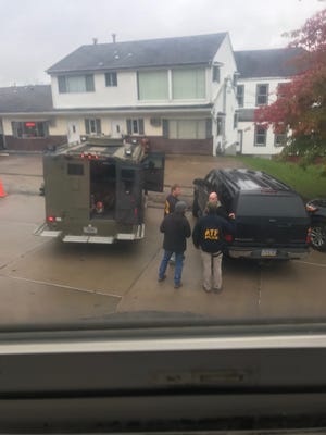 ATF agents gather outside the ground-floor apartment where Pittsburgh synagogue shooting suspect Robert Bowers lives. The building is next door to the apartment where Henry and Chris Capozzi live. Chris took this photo Saturday from his living room window. [Contributed]