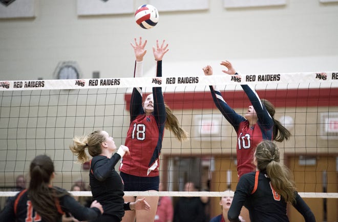 Belvidere North Freshman Rachel Scott (18) and junior Mikayla Gavina jump to block the ball in the third set against St. Charles East at the Class 4A Huntley Sectionals on Monday, Oct. 29, 2018, at Huntley High School. Belvidere North lost to St. Charles East in three sets. [RACHAEL KEATING/RRSTAR.COM CORRESPONDENT]