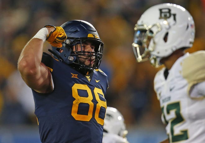 West Virginia tight end Trevon Wesco, left, reacts after a catch in the first half during the Mountaineers' 58-14 win Saturday over Baylor. Coach Dana Holgorsen noted that Wesco was the "player of the game" due to his improved run blocking. [Justin K. Aller/Getty Images]