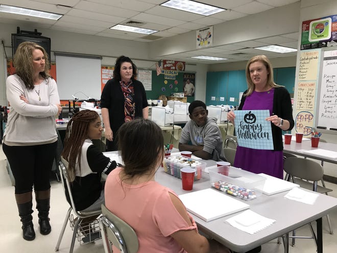 Sandy Gundogdu, a Lumberton parent, showed students how to do a craft with paints and stencils on Monday during a meeting of Lumberton Middle School’s brand-new mentoring club. [LISA RYAN/STAFF PHOTOJOURNALIST]