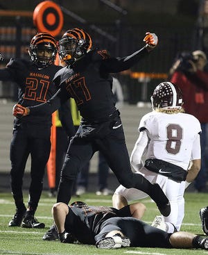 Massillon's Kyshad Mack celebrates a sack of Boardman quarterback Mike O'Horo during the Tigers's first-round playoff win in 2017. (IndeOnline.com / Kevin Whitlock)