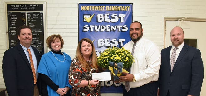 Northwest Elementary School principal Heather Walston holds a check for $2,500 after the school was named winner of the LCPS Challenge Grant for campus beautification. Northwest plans to use the grant funds and a matching amount to build a fully landscaped outdoor classroom. With Walston are, from left, Superintendent Brent Williams, Associate Superintendent Frances Herring, Assistant Superintendent Nicholas Harvey II and Finance Director Eric Adams. [Contributed photo]