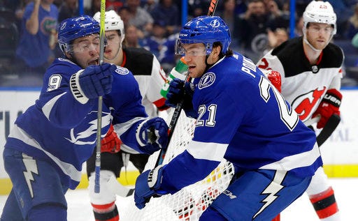 Tampa Bay Lightning center Brayden Point (21) celebrates with center Tyler Johnson (9) after Point scored against the New Jersey Devils during the second period of an NHL hockey game Tuesday, Oct. 30, 2018, in Tampa, Fla. (AP Photo/Chris O'Meara)