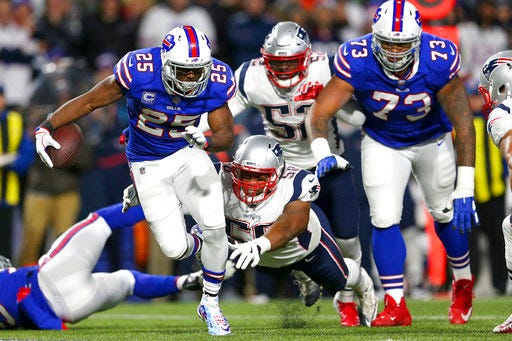 Buffalo Bills running back LeSean McCoy (25) is tripped up by New England Patriots defensive end Keionta Davis (58) during the first half of an NFL football game, Monday, Oct. 29, 2018, in Orchard Park, N.Y. (AP Photo/Jeffrey T. Barnes)