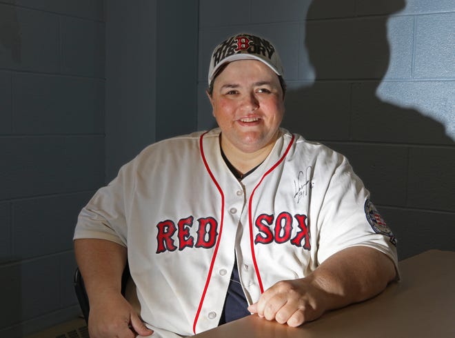 Jeri Schey, who has retinitis pigmentosa, which causes blindness, won tickets from a Papa John's Pizza contest to see the Boston Red Sox in the World Series. [The Providence Journal / Steve Szydlowski]