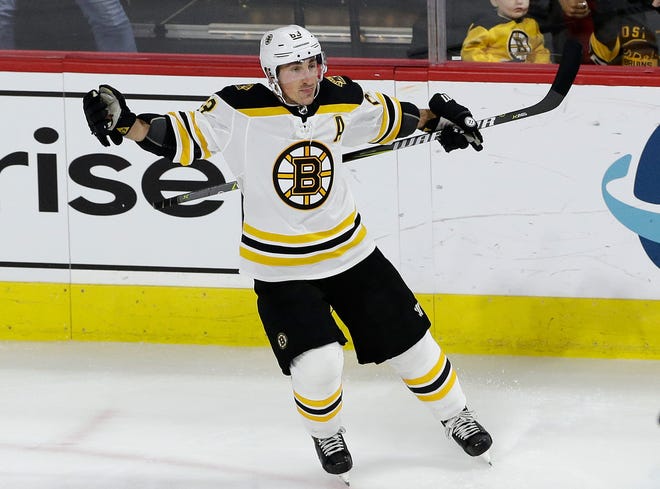 Boston Bruins' Brad Marchand (63) celebrates following his goal against the Carolina Hurricanes during the third period of an NHL hockey game in Raleigh, N.C., Tuesday, Oct. 30, 2018. Boston won 3-2. (AP Photo/Gerry Broome)