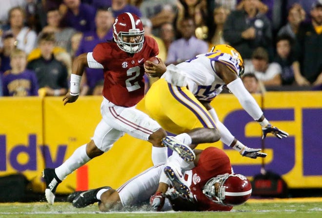 Alabama tight end O.J. Howard (88) puts a block on LSU safety John Battle (26) freeing Alabama quarterback Jalen Hurts (2) to make a run for a first down during Alabama's 10-0 win over LSU in Death Valley Saturday, November 5, 2016. Staff Photo/Gary Cosby Jr.