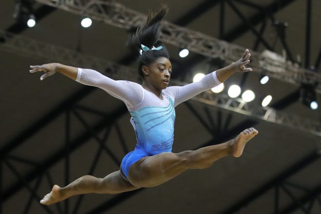 Simone Biles of the U.S. performs on the balance beam during the women's all-around final at the Gymnastics World Championships on Thursday. [Vadim Ghirda/The Associated Press]