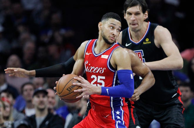 Sixers guard Ben Simmons moves around Clippers center Boban Marjanovic on Thursday. [Laurence Kesterson/Associated Press]