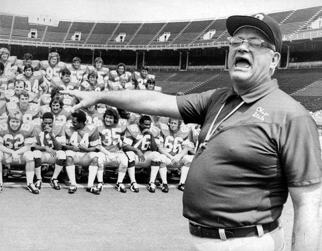Ohio State University football coach Woody Hayes shouts for a photographer to take a picture of his Buckeye squad during picture day at Ohio Stadium on Aug. 25, 1973. [File photo]