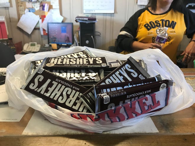 The first donation, a bag full of Hershey's Milk Chocolate Bars dropped off by an unidentified donor at Bridgewater Auto Body, to Angels in America Thursday, Nov. 1, 2018. (Corlyn Voorhees/The Enterprise)