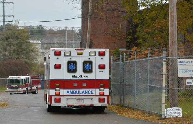 An ambulance stands at a National Grid building on Providence Street in Millbury on Thursday. [T&G Staff/Christine Peterson]